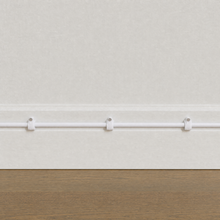 QualGear 4 mm cable clip in white mounted along a light wall, cable run framed to the wall only