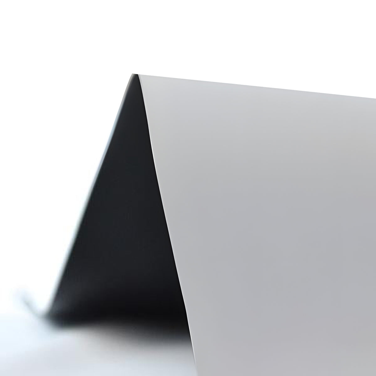 QualGear 100 in gray projector screen fabric, 0.9 gain, folded to show the gray front and dark back