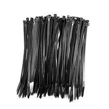 Loose pile of black 4 in QualGear cable ties showing the narrow 2.5 mm straps