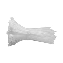 Loose bundle of white 4 in self-locking nylon cable ties showing the locking heads